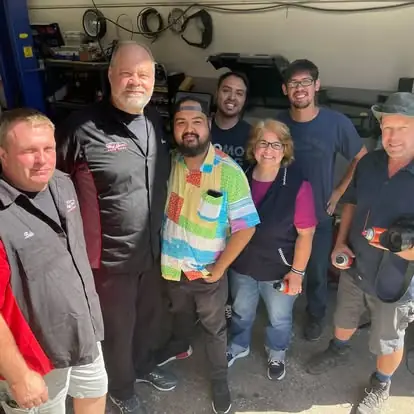 The Big Jim's crew and customers gathered inside the shop bay on Creek Street